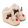 A pair of light beige baby winter cartoon boots with soft fur trim and a non-slip sole.