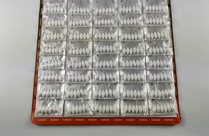 A sheet of 120 oval seven star fishing floats with bobber beads packaged in clear plastic.