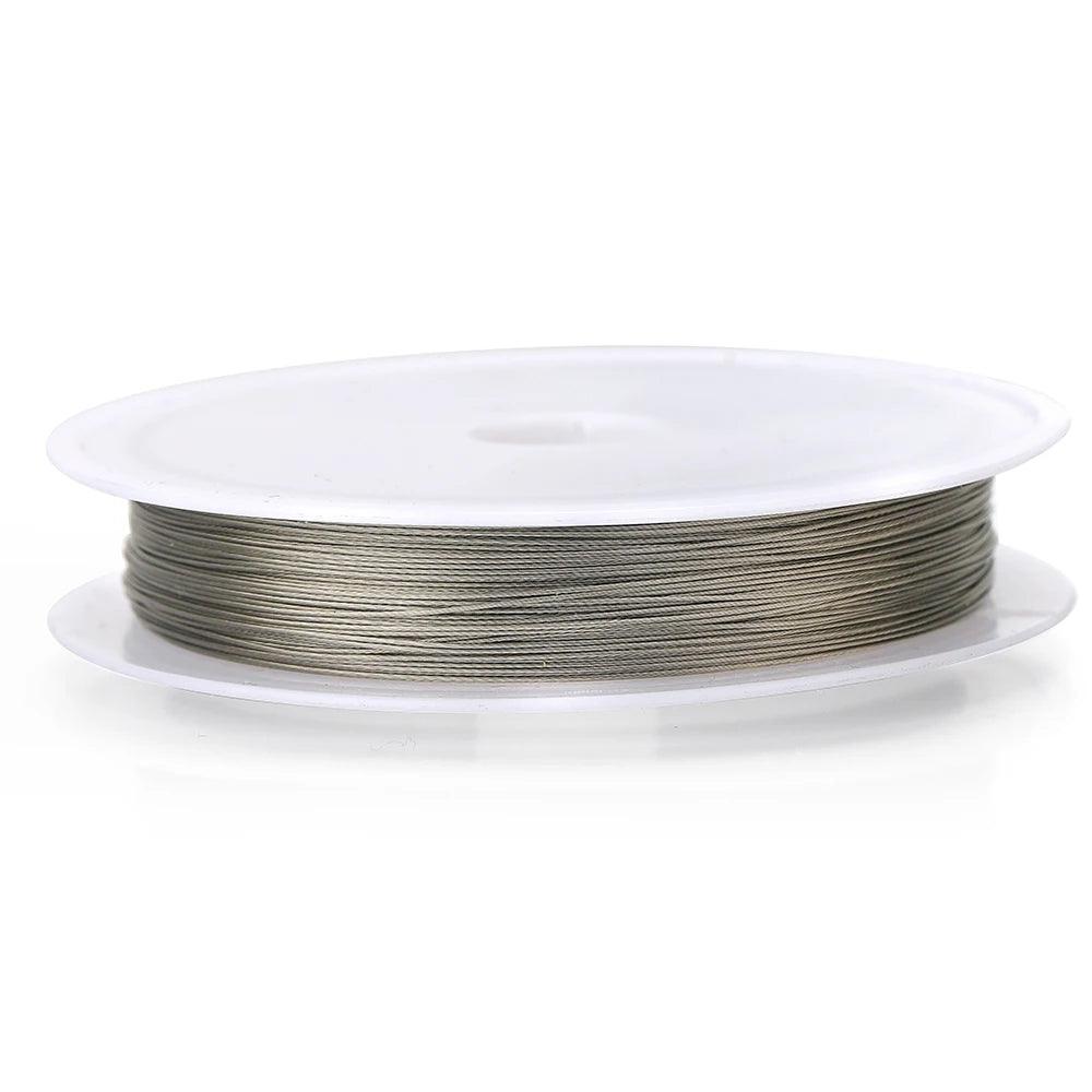 A spool of silver stainless steel beading wire for jewelry making resting on a white plastic disc.