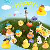 A collection of yellow rubber ducks in various colors and sizes scattered on green grass with a sign saying happy hello