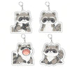 Three acrylic keychains featuring cute raccoon characters with different expressions