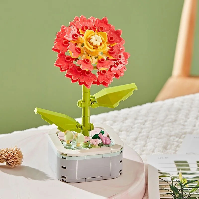 A small building block bouquet set featuring a red and yellow rose flower with green leaves.