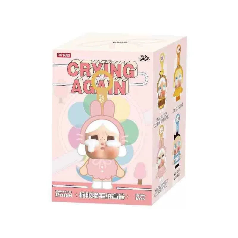 A blind box featuring a crying baby plush figure in a pink box.
