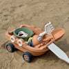 A kids sand and water play set featuring an orange pull-along bulldozer trolley with a shovel and various accessories on sand