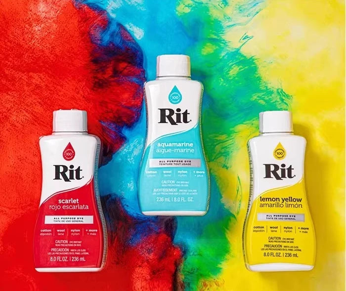 A bottle of Rit scarlet rojo escarlata fabric dye set against a colorful, abstract background.