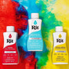 A bottle of Rit aquamarine liquid fabric dye set against a vibrant, colorful abstract background.