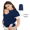 A woman wearing a navy knitted fabric baby carrier with a baby, next to a separate navy travel pouch.