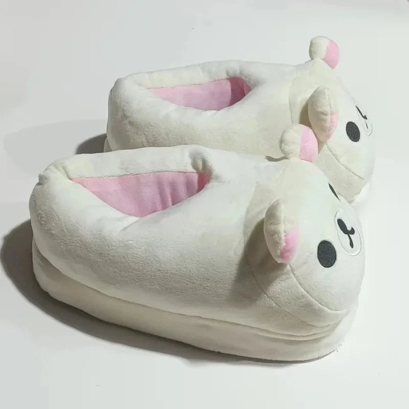 A pair of white Rilakkuma plush indoor slippers with pink accents.