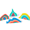 Colorful wooden rainbow blocks arranged on a white background.
