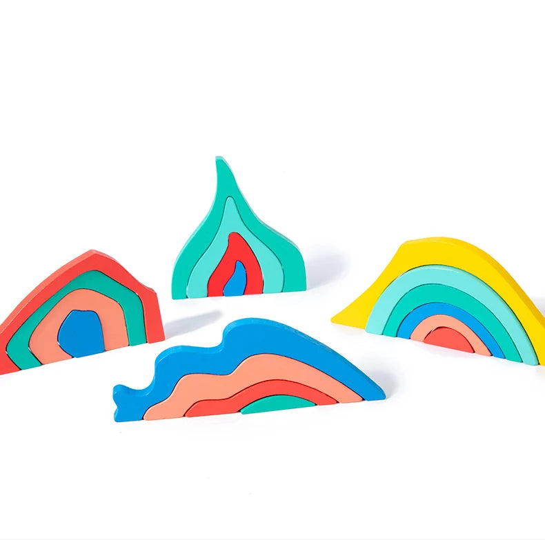 Colorful wooden rainbow blocks arranged on a white background.