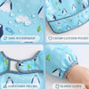A set of light blue waterproof baby bibs with cute penguin designs, showing features like a crumb catcher pocket and adjustab