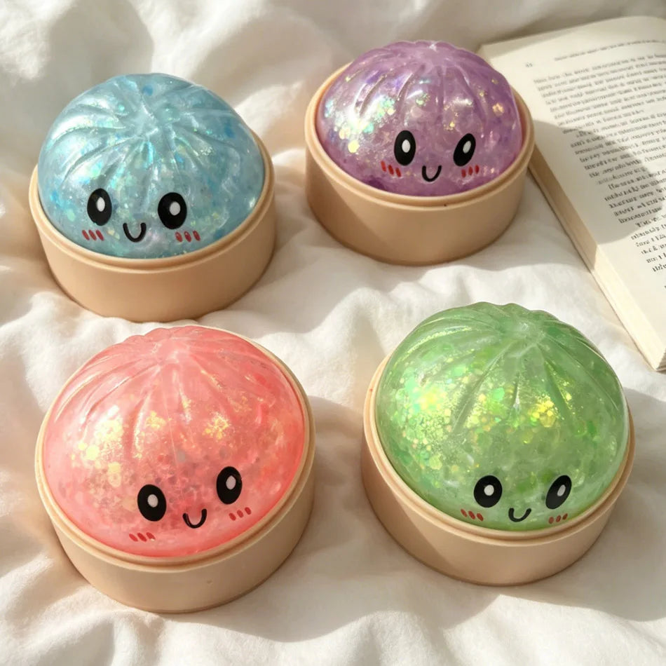 Three colorful glitter sensory squishy fidget toys in round containers: blue, purple, and green.