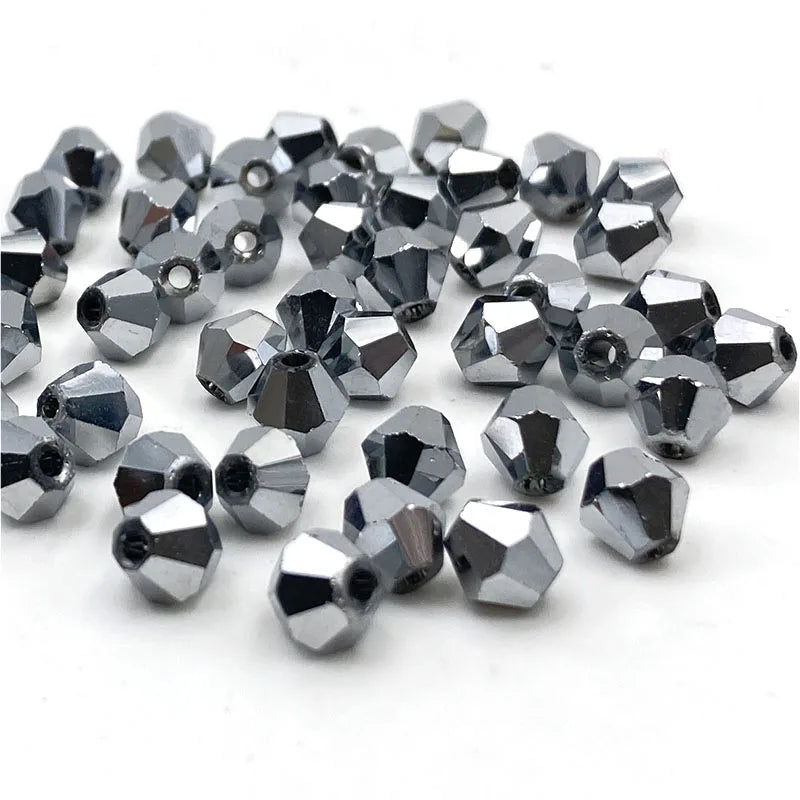 A pile of silver faceted bicone crystal glass beads for jewelry making