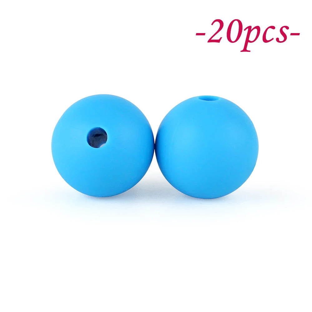 Two bright blue silicone beads, one with a hole, are shown against a white background.