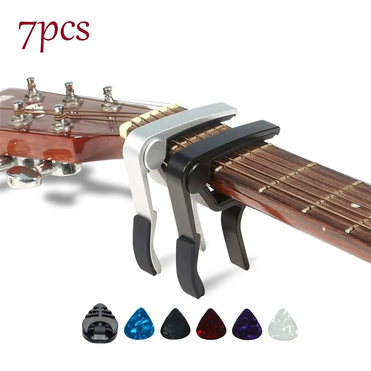 A set of seven guitar capo pieces including picks and a holder displayed on a wooden guitar neck.