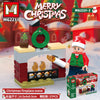 A red Christmas fireplace scene built with wooden blocks and featuring a Santa figure.