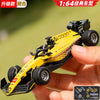A yellow 1:64 scale RC drift car is held in a hand, showing its detailed features and tires.