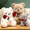 Three teddy bear plush toys in white, beige, and gray colors with red roses attached.