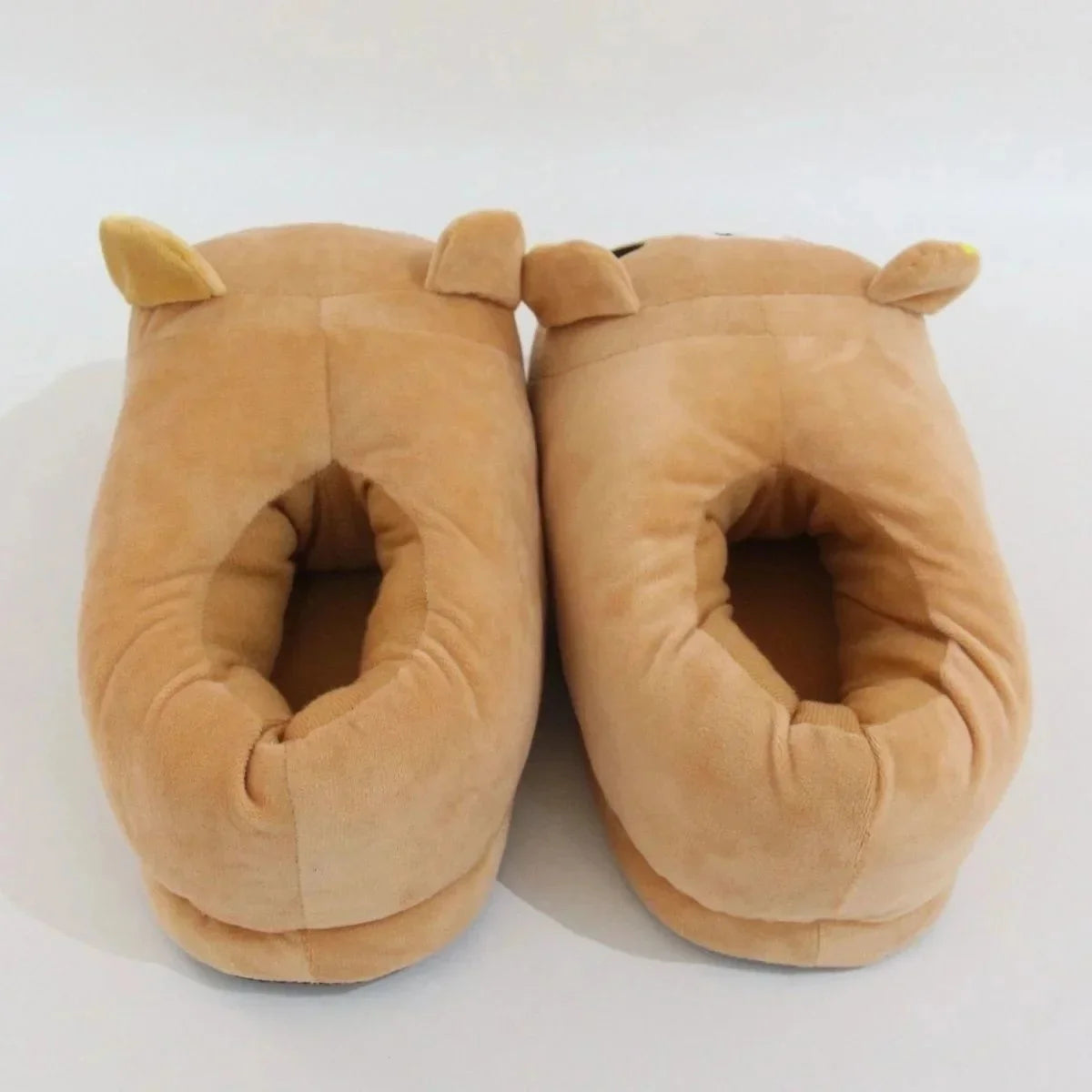 A pair of tan Rilakkuma plush indoor slippers with floppy ears.