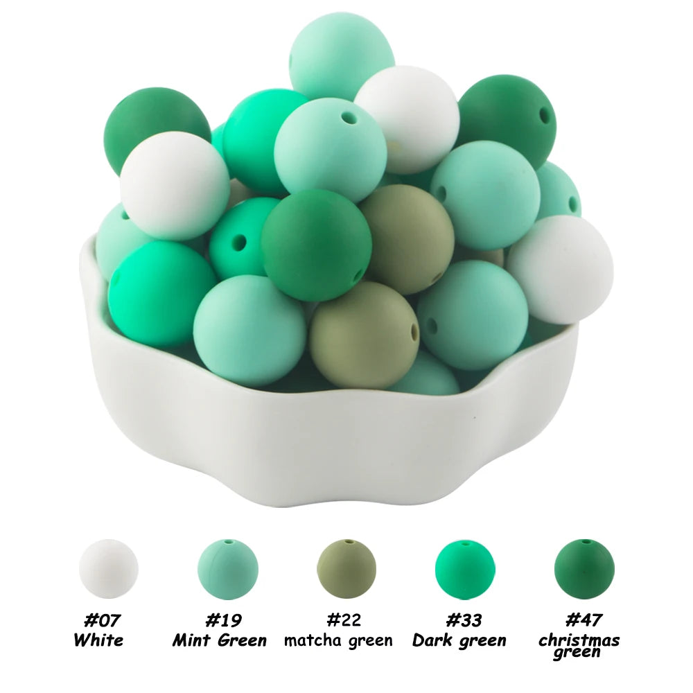 A pile of 50 silicone beads in various shades of green and white for DIY jewelry making