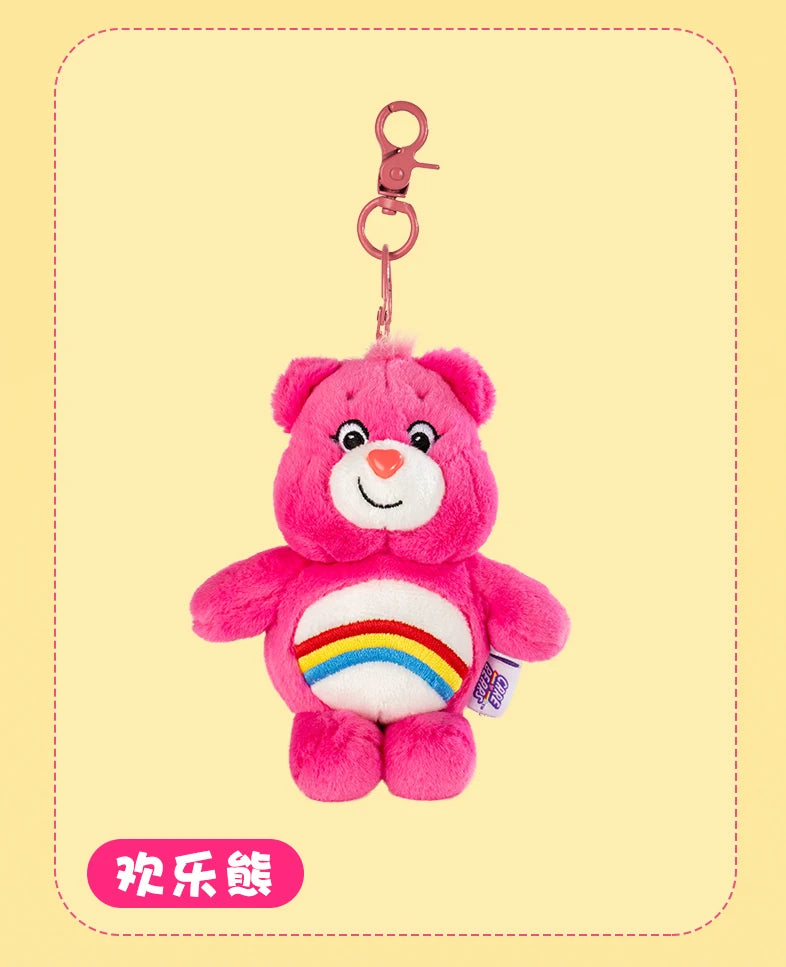 A pink Care Bears plush toy keychain with a rainbow belly, hanging from a metal ring.