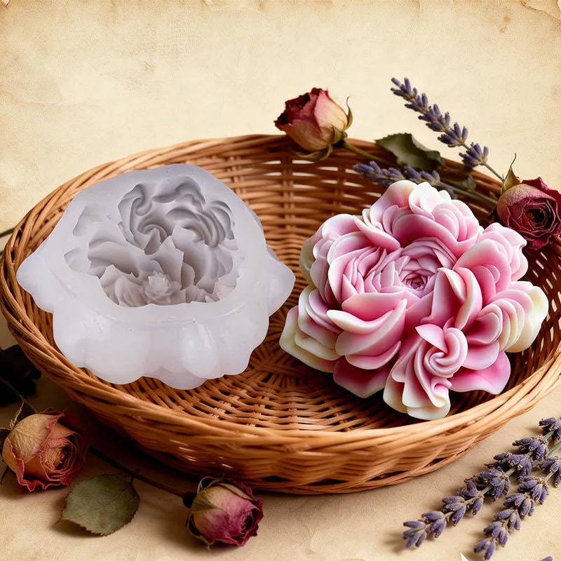 A pink floral silicone candle and resin mold rests in a woven basket surrounded by dried roses and lavender.