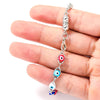 A hand holds a silver magnetic lobster claw clasp jewelry component for making jewelry