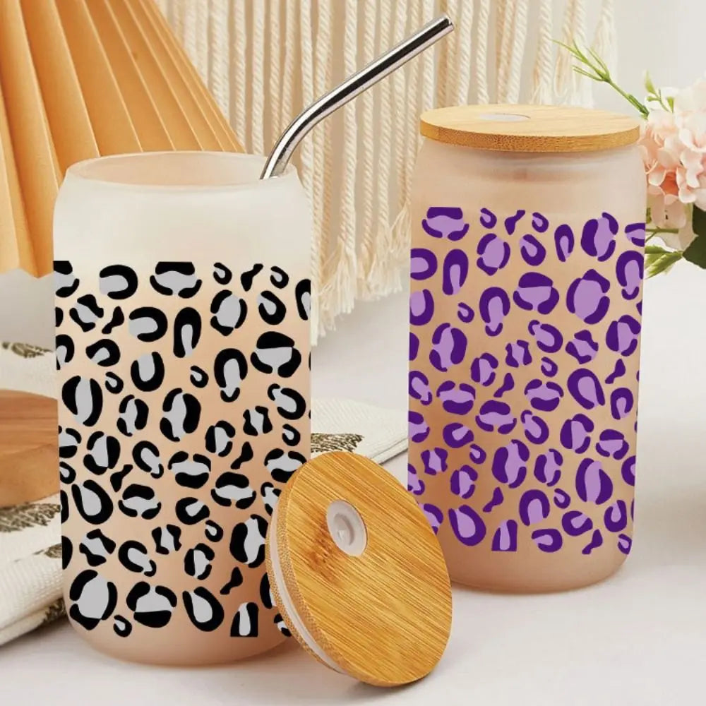 Two light pink cup wraps featuring a leopard print design, with a metal straw visible.
