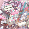 A close-up of a 3D sticker scene book featuring various isometric house designs and elements.