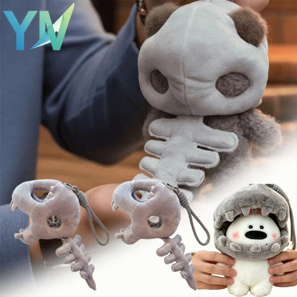 A soft gray dinosaur skeleton bag charm with a removable hood is shown being held by hands.
