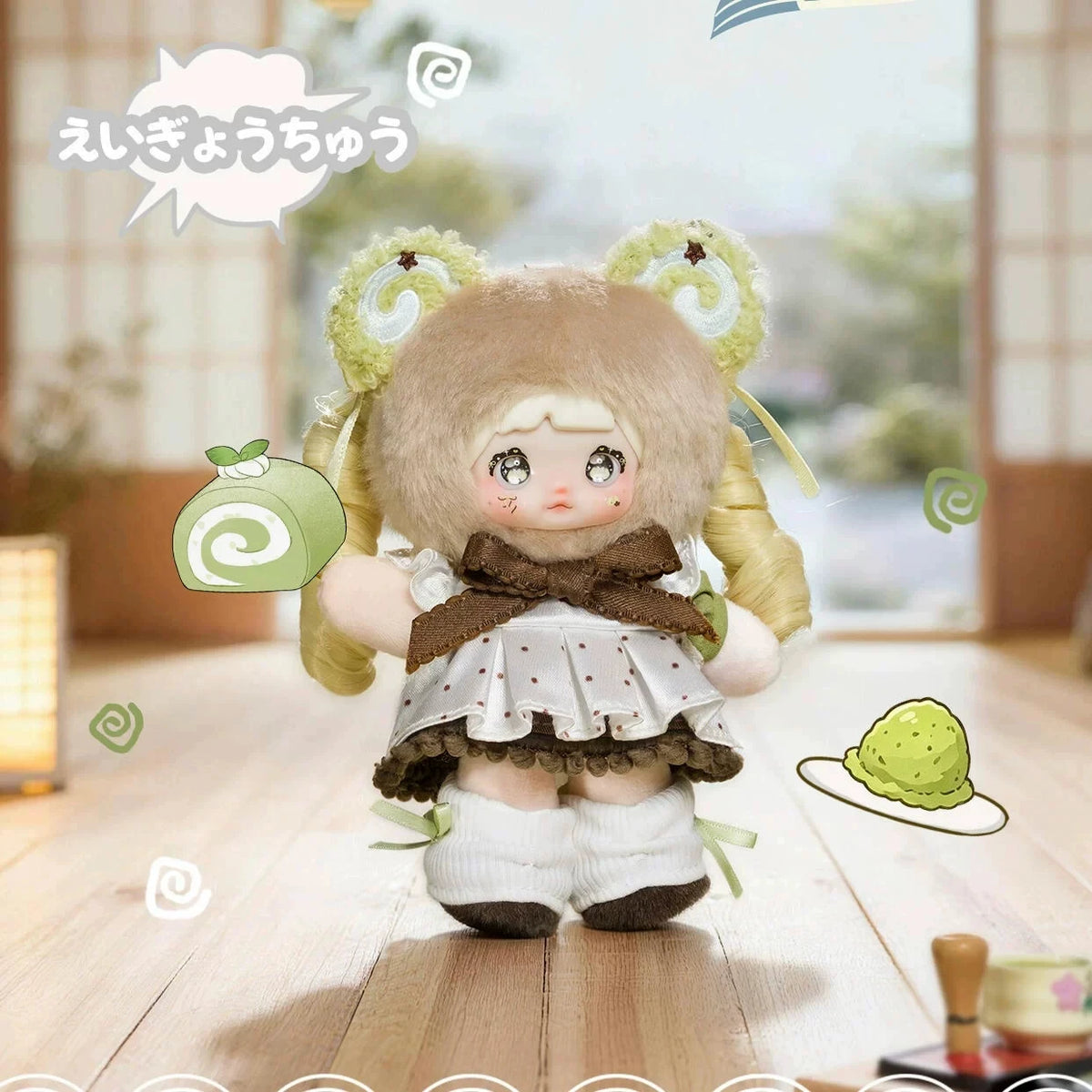 A cute plush keychain of a girl with light brown hair and large eyes wearing a white dress and brown bow, holding a green ite