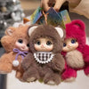 A hand is holding three plush animal pendants: a brown rabbit, a gray bear, and a pink sheep.