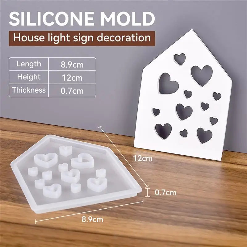 A white silicone mold set for making heart-shaped ornaments, shown next to a finished sign mold.