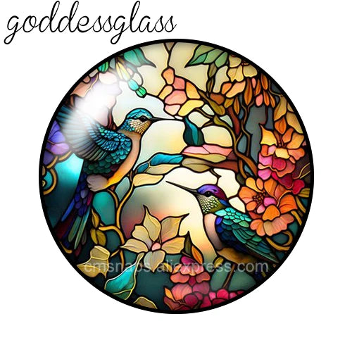 A round glass cabochon featuring a vibrant bird surrounded by floral elements.