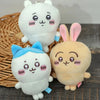 A collection of three soft white and pink Chiikawa Usagi plush keychains with different ear colors and accessories.