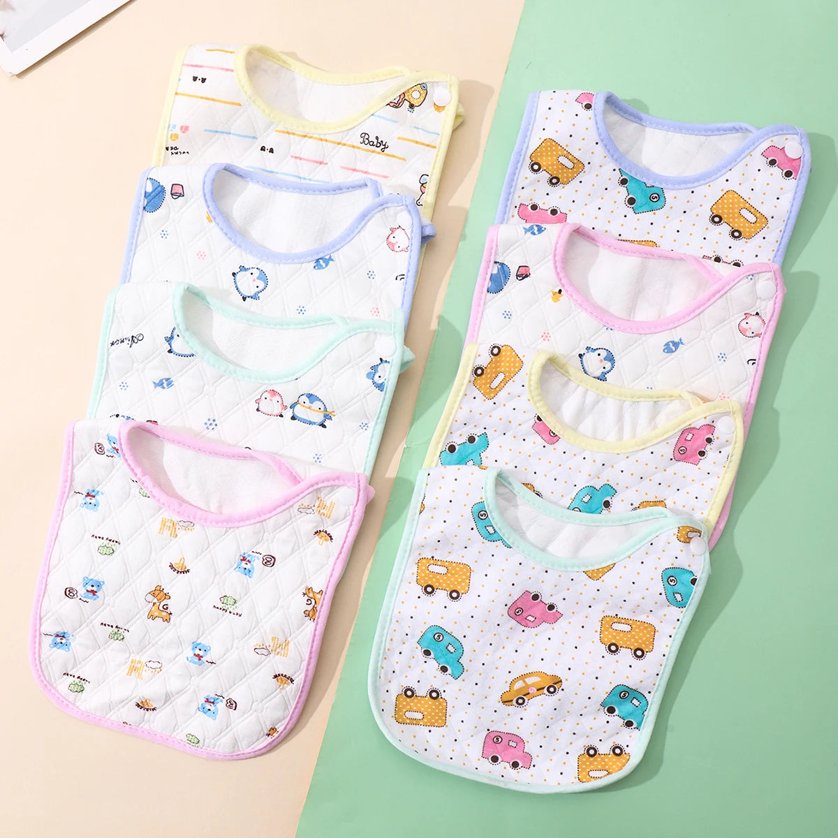 A pack of three soft cotton baby bibs with adjustable closures featuring various cute animal and vehicle patterns.