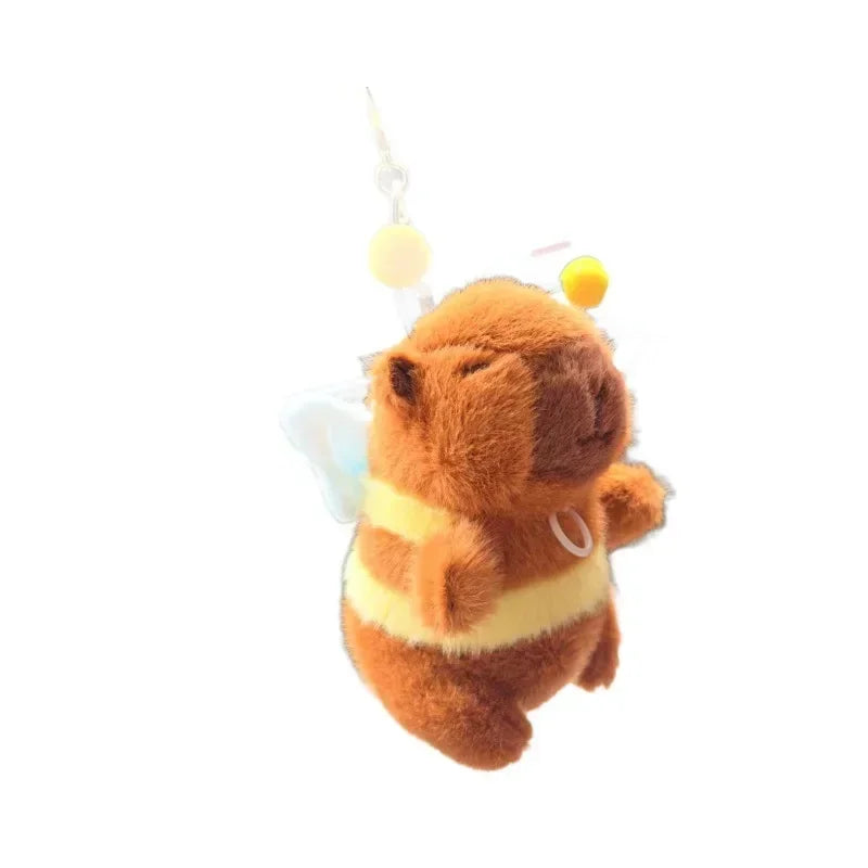 An orange capybara plush toy with yellow accents attached to a keychain.
