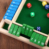 A wooden dice game set featuring blue and green dice arranged on a green felt board.