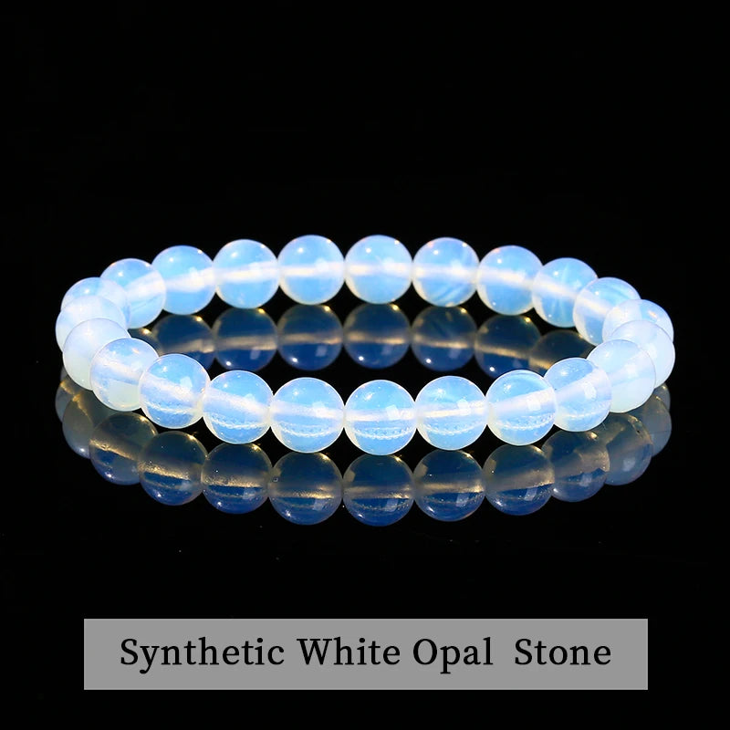 A close-up of a natural pink quartz stretch bracelet displayed on a dark background.