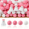 A collection of pink and white silicone beads shaped like ghosts for jewelry and crafting.
