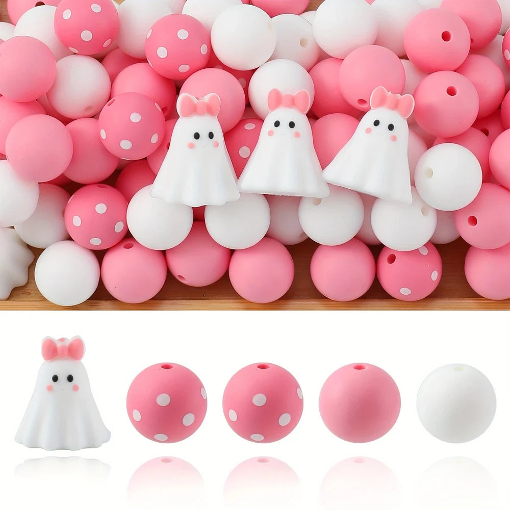 A collection of pink and white silicone beads shaped like ghosts for jewelry and crafting.