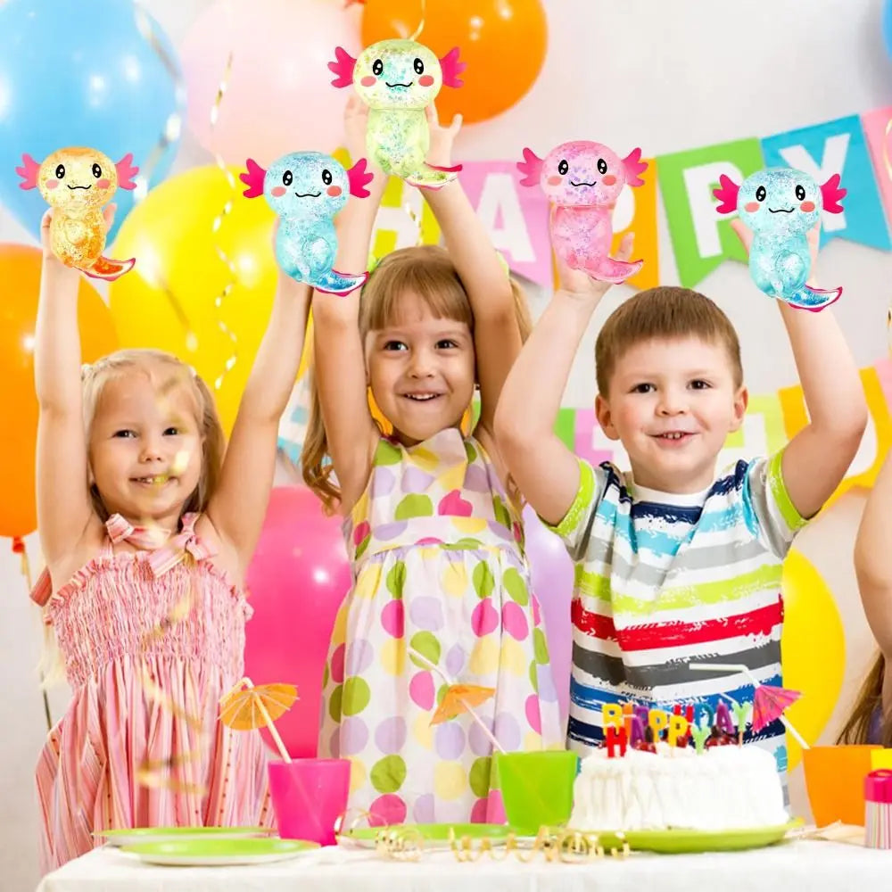 Three children are holding colorful squishy axolotl fidget toys in a birthday party setting.