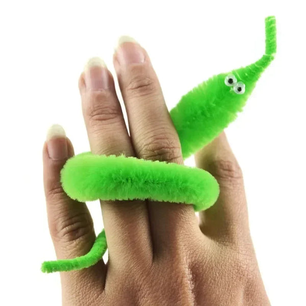 A hand holds a bright green magician show worm toy with a long, slender body.