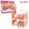 A wooden bedroom set playhouse featuring a bed, nightstand, and decorative elements for a dollhouse.