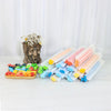 A collection of 50 silicone soap and candle molds in various colors and shapes arranged next to a dried floral arrangement.