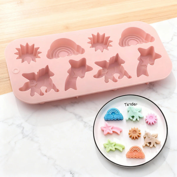 Rosa Silikon-Dessertform mit verschiedenen Einhorn- und Regenbogenformen auf weißem Marmor