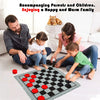 A family enjoying a game of checkers and tic-tac-toe on a large checkered rug.
