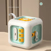 A white Montessori pop-up animal toy with a yellow top, featuring a hide and seek sensory game for toddlers.