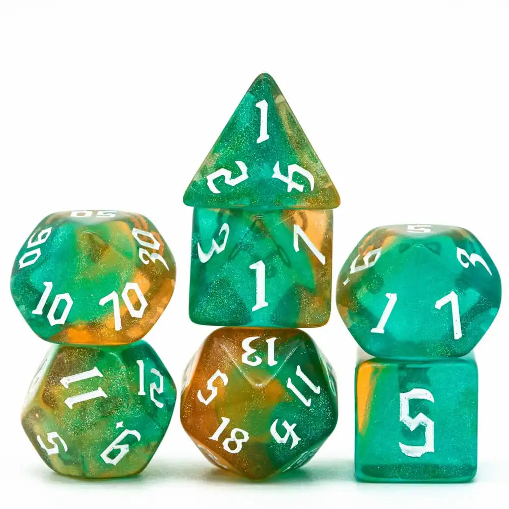 A set of seven translucent green and amber polyhedral dice arranged in a pyramid shape.