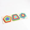 A wooden geometric shape sorter puzzle featuring colorful, interlocking shapes in various shades of blue, green, and orange.